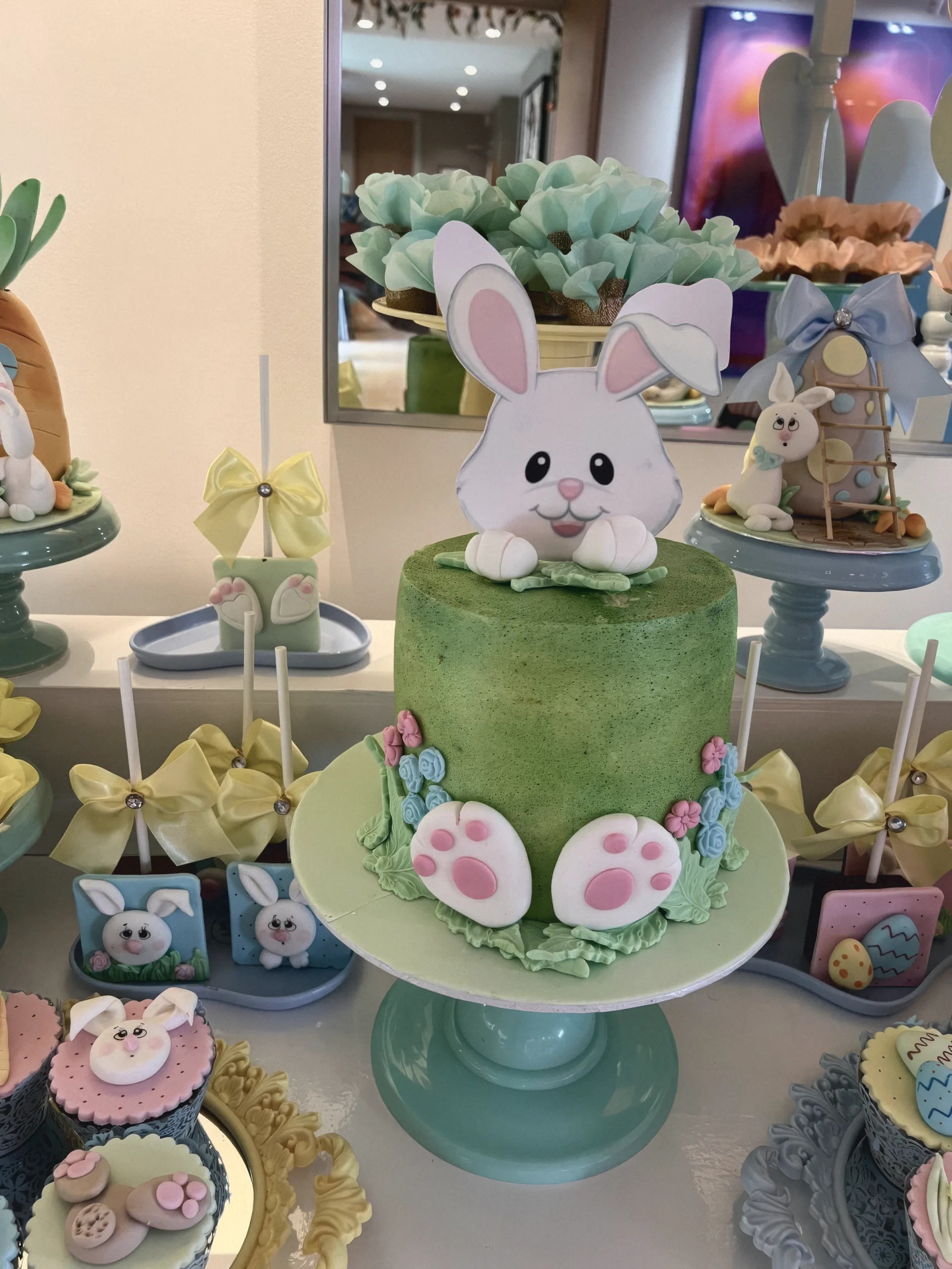 A green Easter cake with a sugar bunny and bunny feet