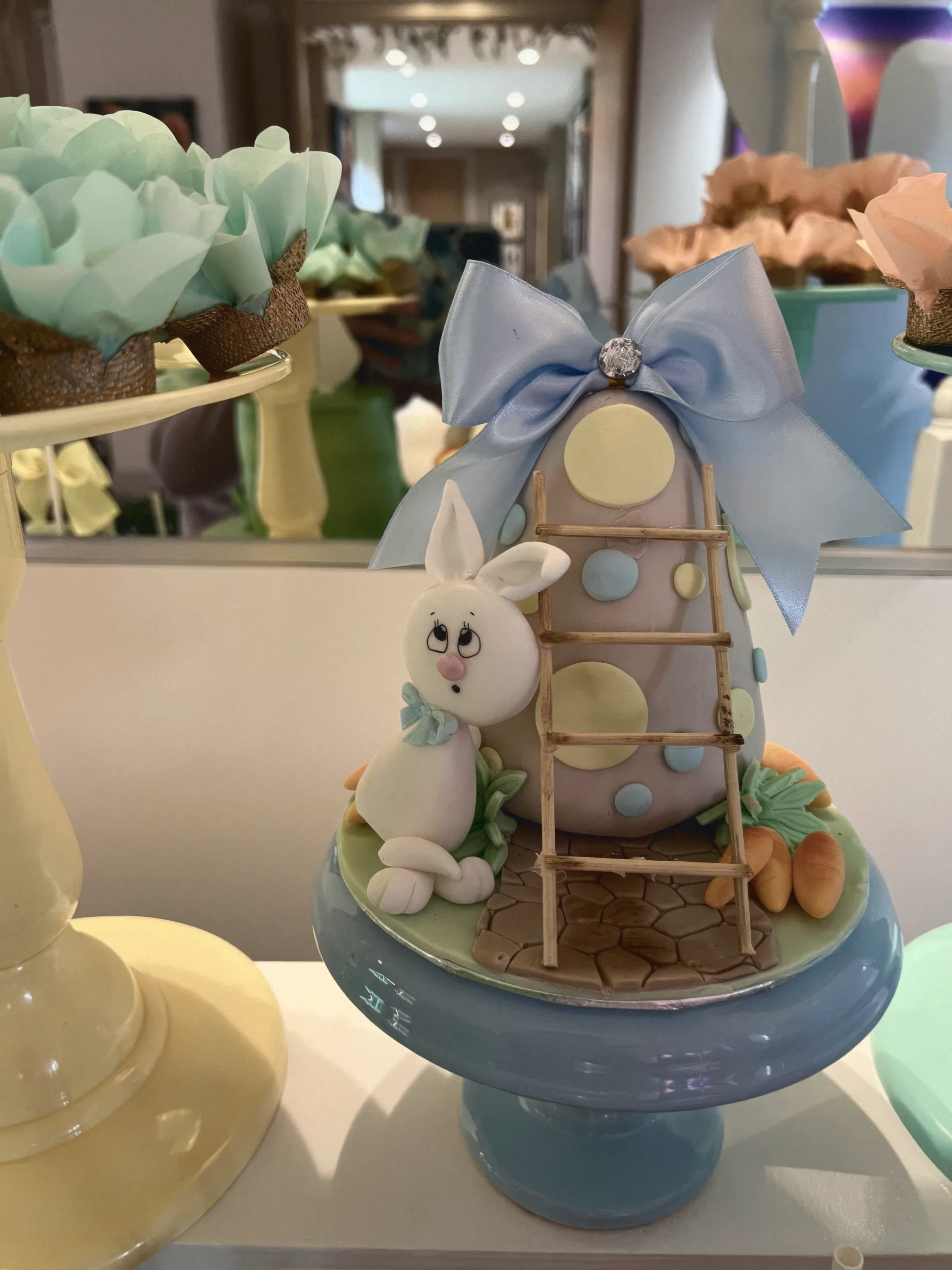 A decorated egg with a sugar bunny climbing a little ladder