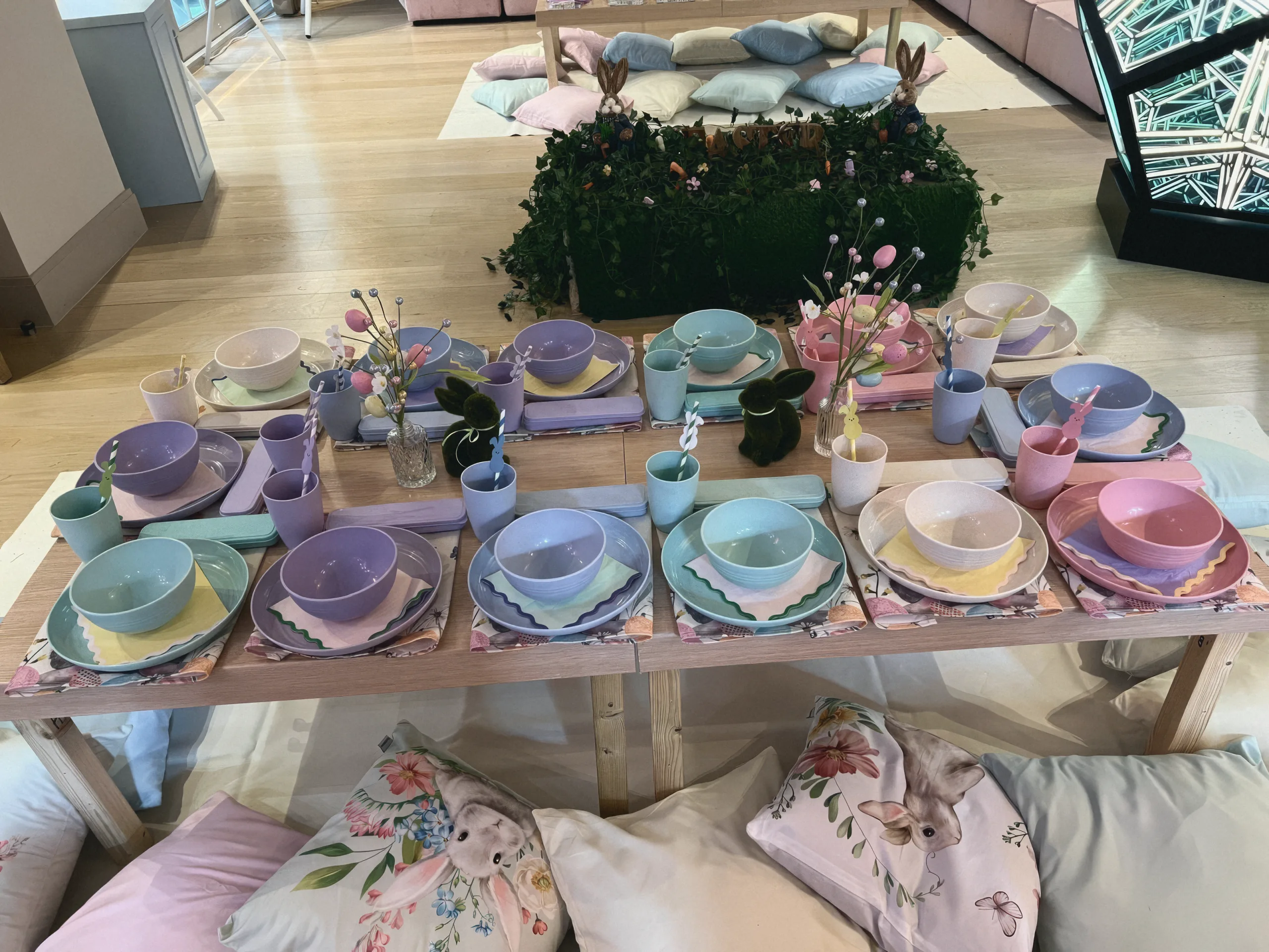 A low table set with pastel plates, bowls and cups for children